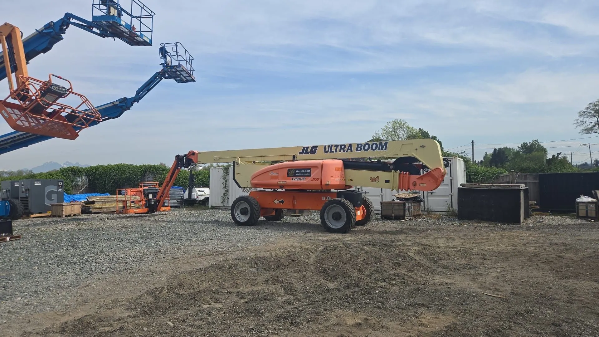 Global Lions Rental boom lifts lined up in the equipment yard