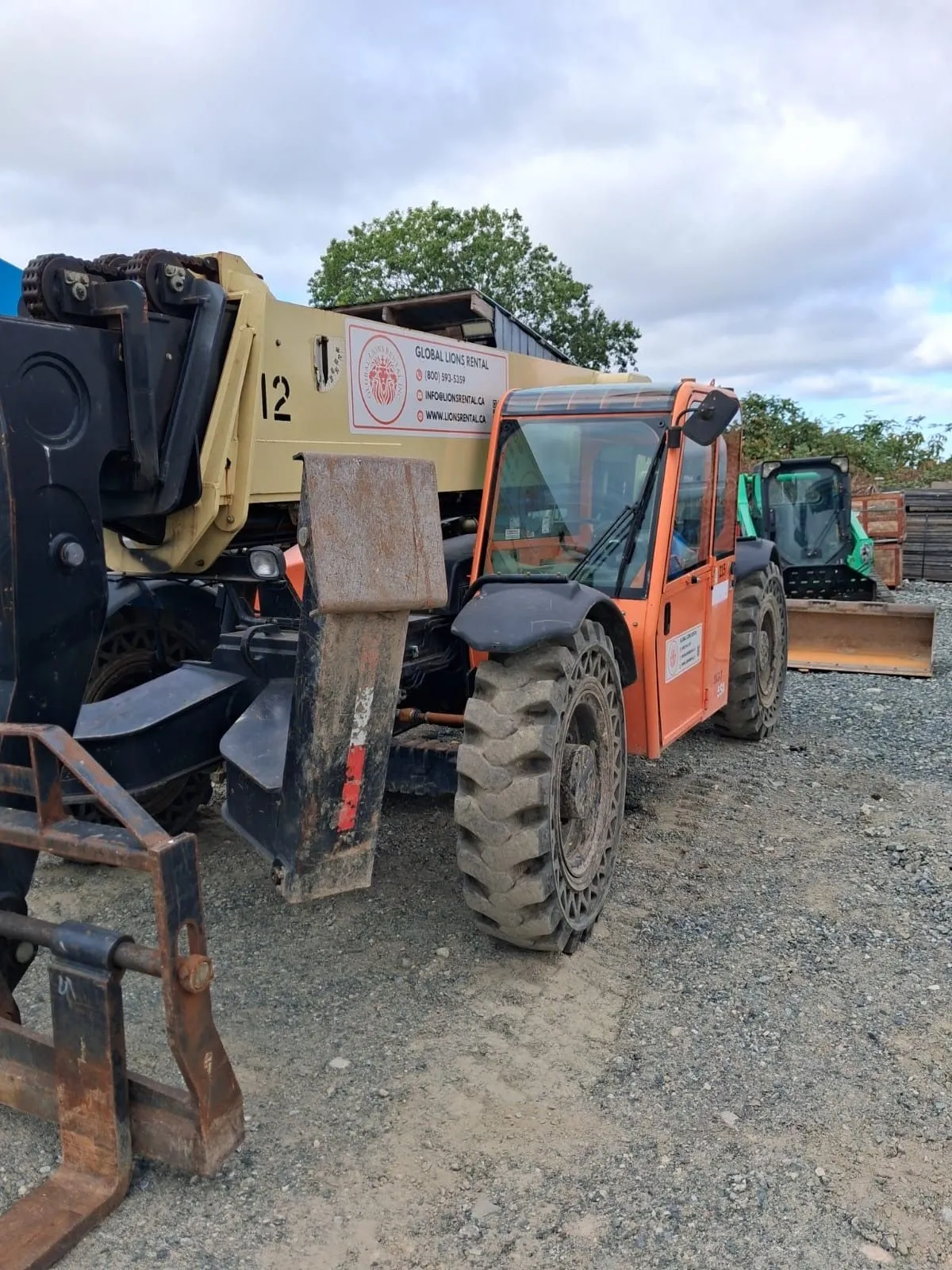Orange Global Lions Rental telehandler parked at the equipment yard